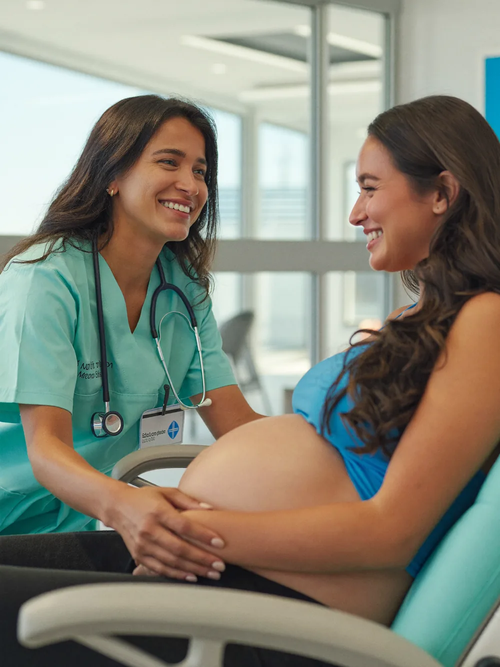A gynecologist warmly reassuring a pregnant patient at German Medical Center, Dubai Healthcare City