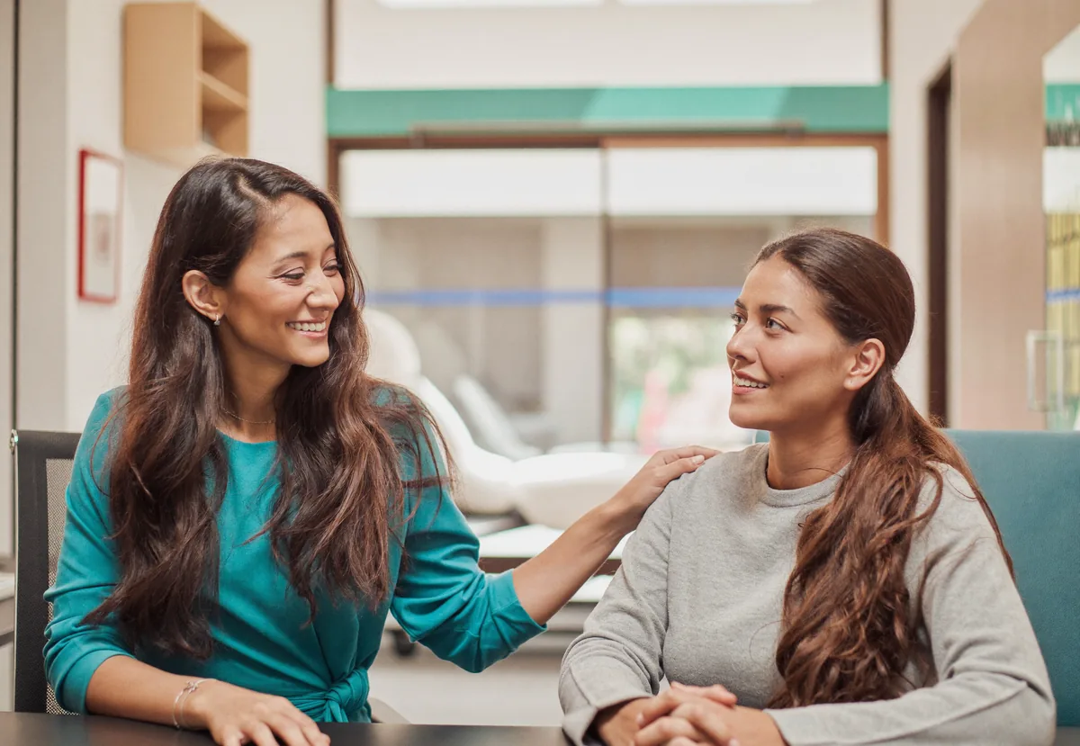 A gynecologist reassuring a young woman during a PCOS consultation at German Medical Center Dubai