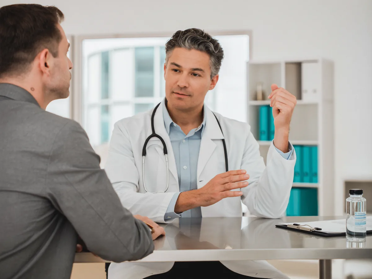 A urologist discussing prostate health with a male patient at German Medical Center Dubai
